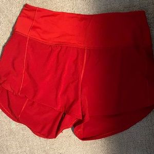 Size 8 tall lululemon shorts in red (never worn)